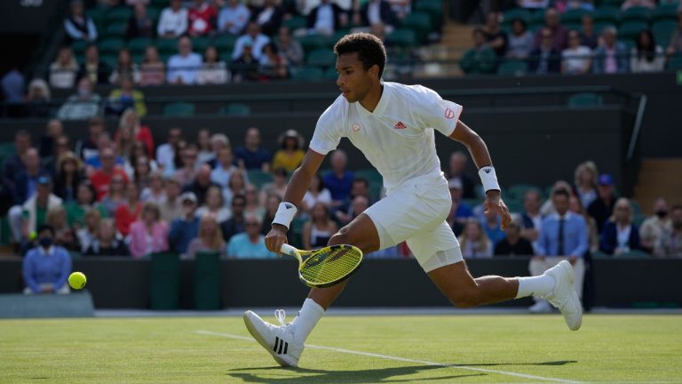 Canada's Felix Auger-Aliassime plays a return to Italy's Matteo Berrettini during the men's singles quarterfinals match on day nine of the Wimbledon Tennis Championships in London, Wednesday, July 7, 2021. (Alastair Grant/AP) 
