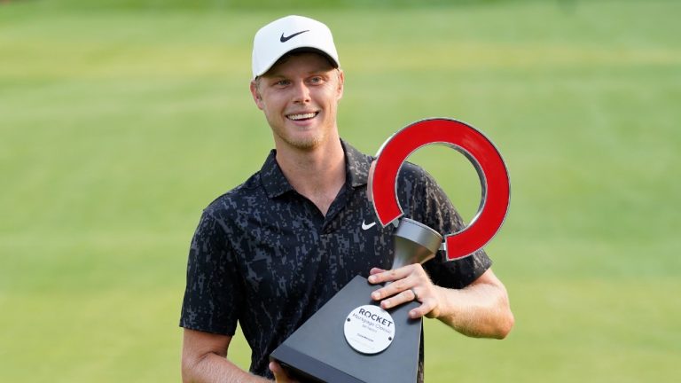 Cam Davis of Australia holds the winner's trophy after the final round of the Rocket Mortgage Classic golf tournament, Sunday, July 4, 2021, at the Detroit Golf Club in Detroit. Davis won on the fifth playoff hole. (Carlos Osorio/AP) 