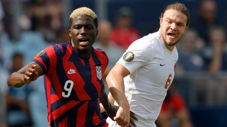 United States forward Gyasi Zardes (9) chases down the ball as Canada midfielder Samuel Piette (6) defends during the first half of a CONCACAF Gold Cup soccer match in Kansas City, Kan., Sunday, July 18, 2021. (Colin E. Braley/AP)