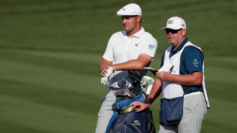 Bryson DeChambeau and his caddie Tim Tucker, look down the 15th fairway, during the first round of The Players Championship golf tournament Thursday, March 12, 2020 in Ponte Vedra Beach, Fla. (Lynne Sladky/AP) 