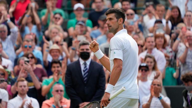 Serbia's Novak Djokovic celebrates during the men's singles third round match against a return to Denis Kudla of the US on day five of the Wimbledon Tennis Championships in London, Friday July 2, 2021. (Alberto Pezzali/AP)