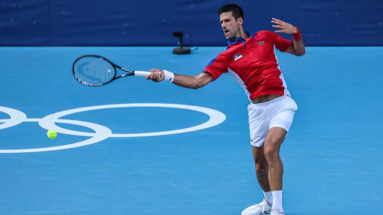 Serbia's Novak Djokovic returns a shot to Bolivia's Hugo Dellien during their Tokyo 2020 Olympic Games men's singles first round tennis match at the Ariake Tennis Park in Tokyo. ( Giuseppe Cacace/Getty Images)