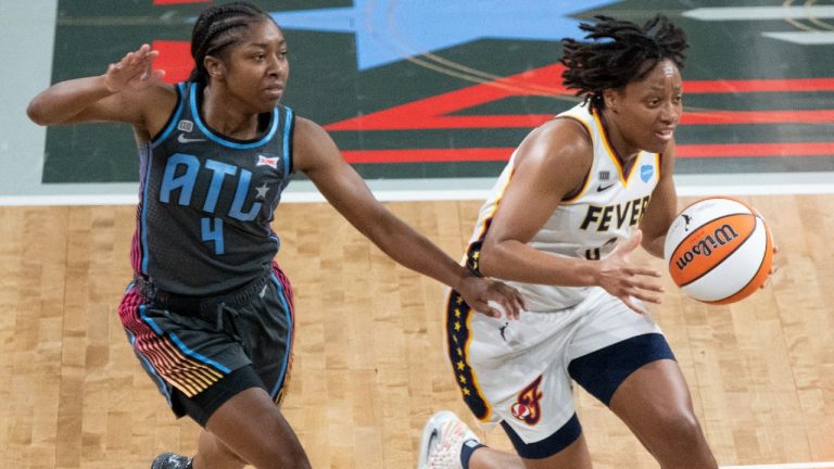 Indiana Fever guard Kysre Gondrezick, right, drives by Atlanta Dream guard Aari McDonald, left, in first half of a WNBA basketball game.Sunday, July 15, 2021, in College Park, Ga. (Hakim Wright Sr./AP) 