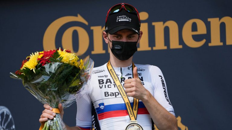 Stage winner Slovenia's Matej Mohoric celebrates on the podium after the nineteenth stage of the Tour de France cycling race. (Daniel Cole/AP)