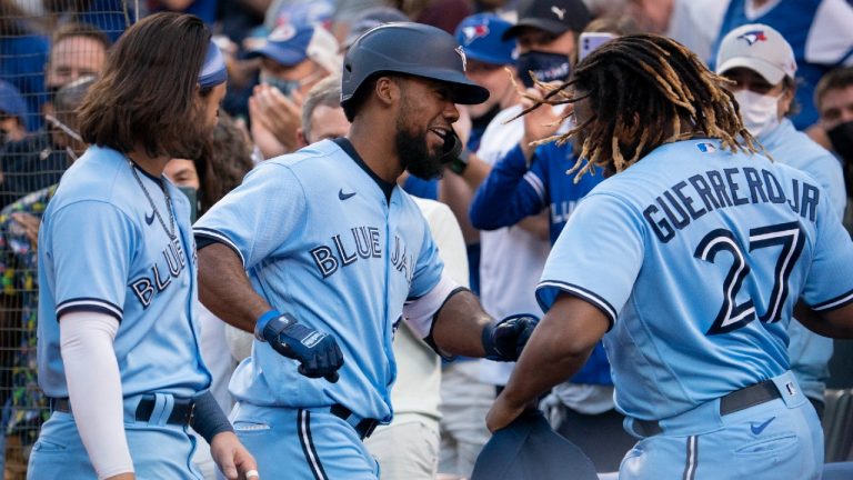 Toronto Blue Jays right fielder Teoscar Hernandez (37) celebrates with teammate Vladimir Guerrero Jr. (27) after hitting a solo home run against the Kansas City Royals during second inning MLB action in Toronto on Friday, July 30, 2021. (Peter Power/CP)