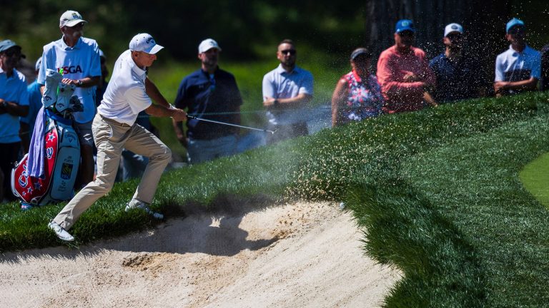 Jim Furyk hits a shot off the lip of a bunker during the final round of the of the U.S. Senior Open golf tournament. (Z Long/AP) 