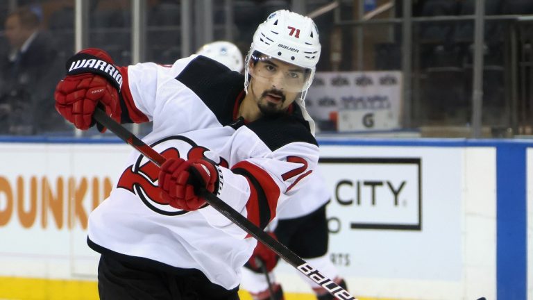 In this April 15, 2021 photo, New Jersey Devils' Jonas Siegenthaler shoots during warmups prior to a game against the New York Rangers in New York. (Bruce Bennett/Pool Photo via AP) 