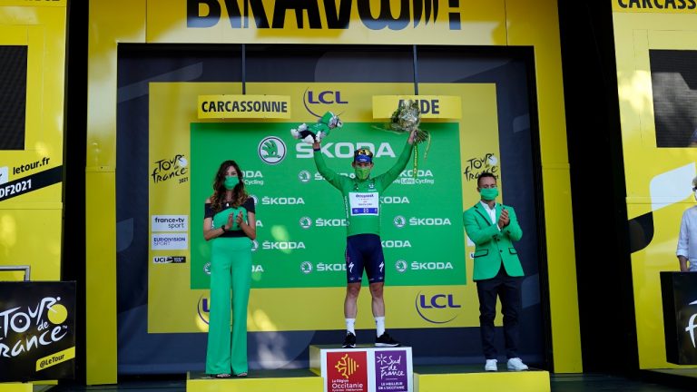 Britain's Mark Cavendish, wearing the best sprinter's green jersey, celebrates on the podium of the thirteenth stage of the Tour de France cycling race over 219.9 kilometres (136.6 miles) with start in Nimes and finish in Carcassonne, France, Friday, July 9, 2021. (Daniel Cole/AP) 