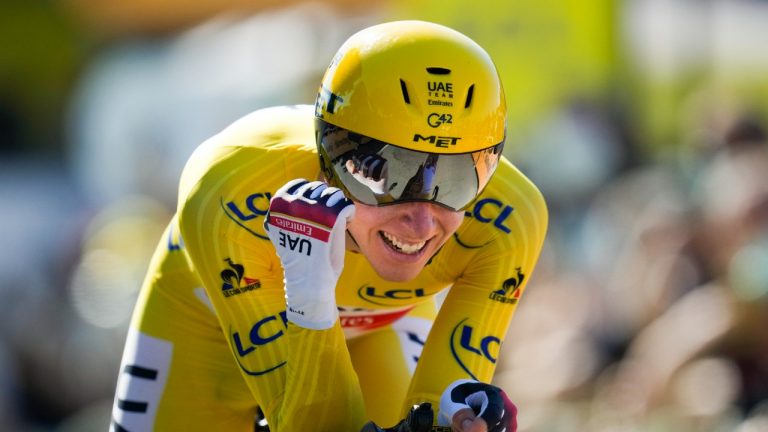 Slovenia's Tadej Pogacar, wearing the overall leader's yellow jersey, celebrates as he crosses the finish line of the twentieth stage of the Tour de France cycling race, an individual time-trial over 30.8 kilometers (19.1 miles) with start in Libourne and finish in Saint-Emilion, France, Saturday, July 17, 2021. (Daniel Cole/AP)