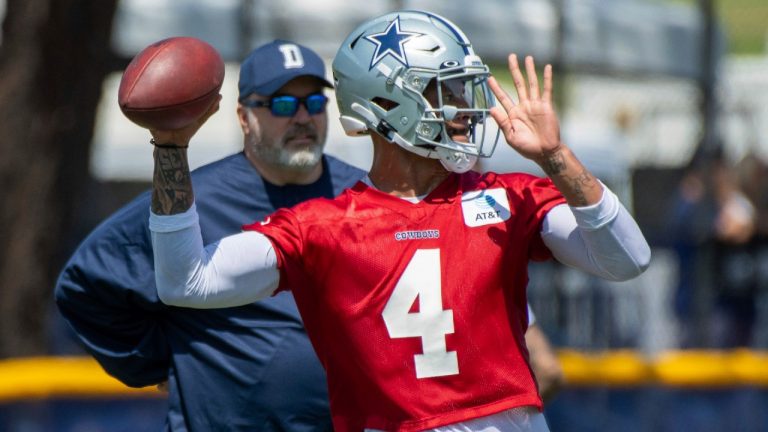 Dallas Cowboys quarterback Dak Prescott throws a pass as coach Mike McCarthy watches during the NFL football team's training camp in Oxnard, Calif., in this Thursday, July 22, 2021, file photo. (Michael Owen Baker/AP)