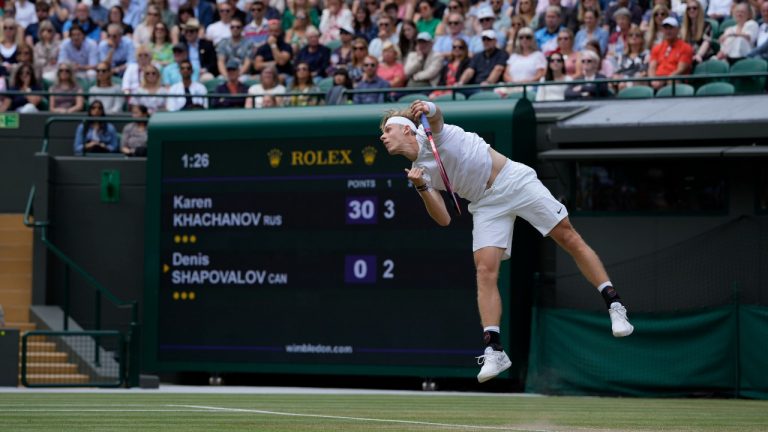 Canada's Denis Shapovalov plays a return to Russia's Karen Khachanov during the men's singles quarterfinals match on day nine of the Wimbledon Tennis Championships in London, Wednesday, July 7, 2021. (Alastair Grant/AP)