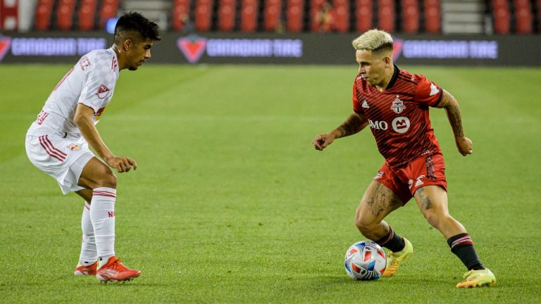 Toronto FC midfielder Yeferson Soteldo (30) is defended by New York Red Bulls midfielder Omir Fernandez (21) during second half MLS soccer action in Toronto, on Wednesday, July 21, 2021. (Chris Katsarov/CP)