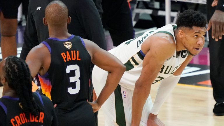 Phoenix Suns guard Chris Paul (3) walks past Milwaukee Bucks forward Giannis Antetokounmpo during the second half of Game 2 of basketball's NBA Finals, Thursday, July 8, 2021, in Phoenix. (Matt York/AP)