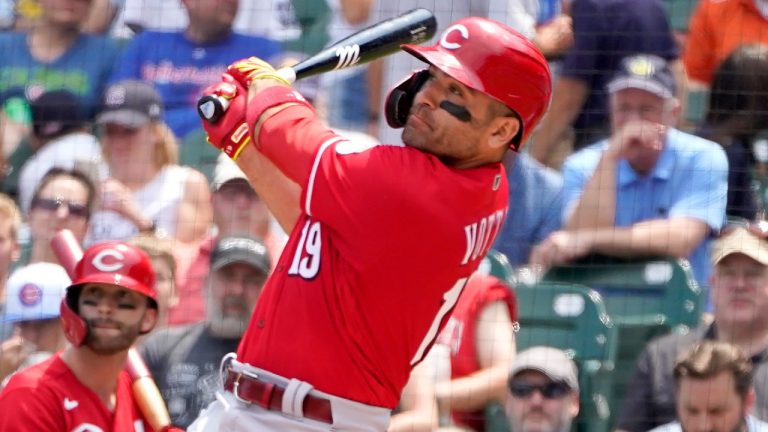 Cincinnati Reds' Joey Votto, right, and Tyler Naquin watch Votto's two-run home run off Chicago Cubs starting pitcher Alec Mills during the first inning of a baseball game Thursday, July 29, 2021, in Chicago. Jesse Winker also scored on the play. (Charles Rex Arbogast/AP)