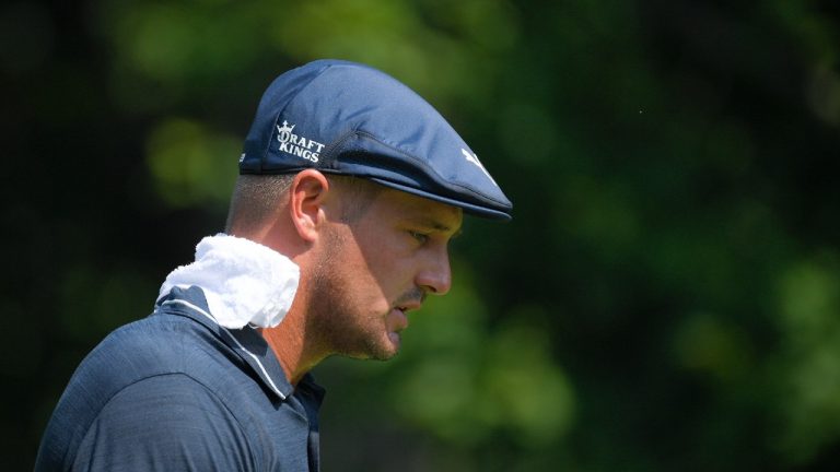 Bryson DeChambeau wears a towel on his neck during high temperatures after teeing off on the second hole during the second round of the BMW Championship golf tournament, Friday, Aug. 27, 2021, at Caves Valley Golf Club in Owings Mills, Md (Nick Wass/AP).