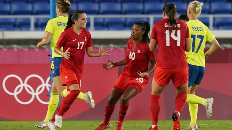 Canada's Jessie Fleming celebrates with teammates Ashley Lawrnce (centre) and Vanessa Gilles after scoring on a penalty kick. (Adrian Wyld/CP)