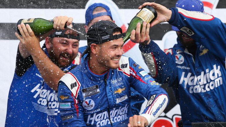 Kyle Larson, center, celebrates with his pit crew after winning a NASCAR Cup Series auto race in Watkins Glen, N.Y., on Sunday, Aug. 8, 2021. (Joshua Bessex/AP)