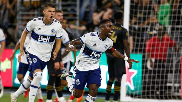 Vancouver Whitecaps midfielder Cristian Dajome, right, celebrates his goal next to defender Cristian Gutierrez during the first half of an MLS soccer match against Los Angeles FC. (Ringo H.W. Chiu/AP) 