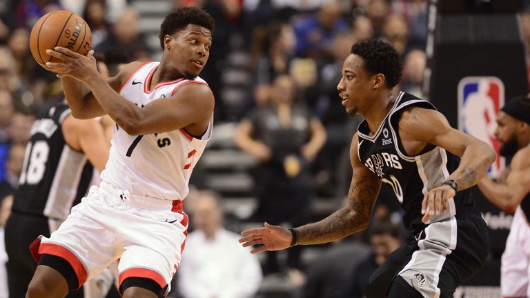 Toronto Raptors guard Kyle Lowry (7) controls the ball as former teammate San Antonio Spurs guard DeMar DeRozan (10) defends. (Frank Gunn/CP)