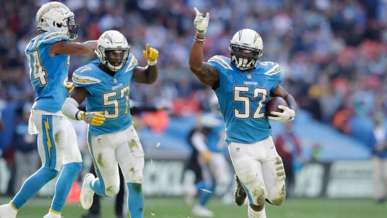 Los Angeles Chargers linebacker Denzel Perryman (52) celebrates stealing the ball during the first half of an NFL football game against Tennessee Titans at Wembley stadium in London, Sunday, Oct. 21, 2018. (Matt Dunham / AP)