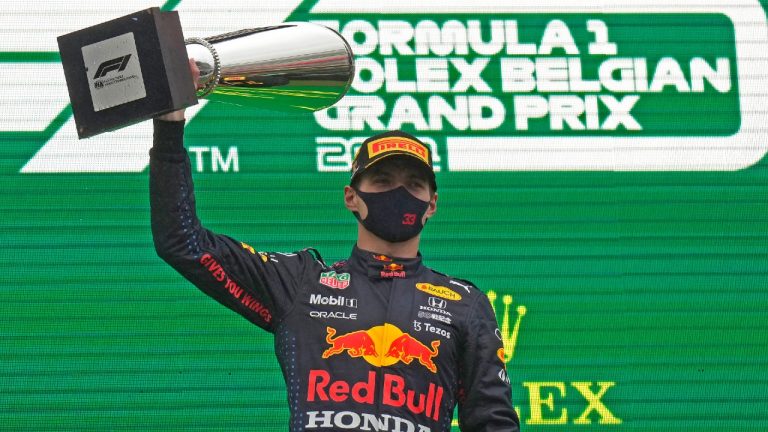 Red Bull driver Max Verstappen holds up the trophy on the podium after winning the Formula One Grand Prix at the Spa-Francorchamps racetrack in Spa, Belgium. (Francisco Seco/AP)