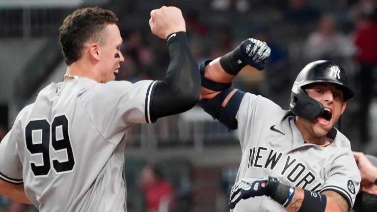 New York Yankees second baseman Rougned Odor (12) celebrates with Aaron Judge (99) after hitting a solo home run in the seventh inning of a baseball game against the Atlanta Braves Tuesday, Aug. 24, 2021, in Atlanta (John Bazemore/AP). 
