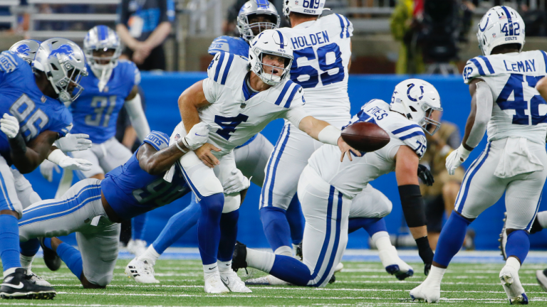 Indianapolis Colts quarterback Sam Ehlinger (4) laterals the ball to running back Benny LeMay (42) after being tackled by Detroit Lions defensive tackle Jashon Cornell during the second half of a preseason NFL football game, Friday, Aug. 27, 2021, in Detroit. (Duane Burleson / AP)