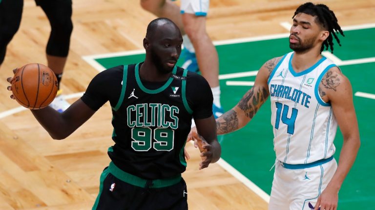 Boston Celtics' Tacko Fall (99) is defended by Charlotte Hornets' Nick Richards (14) during the second half of an NBA basketball game, Sunday, April 4, 2021, in Boston. (Michael Dwyer/AP) 
