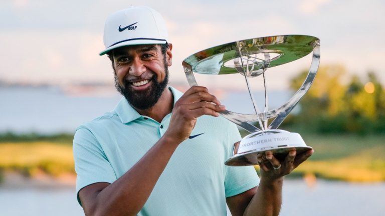 Tony Finau poses with the Wanamaker Trophy after winning The Northern Trust golf tournament at Liberty National Golf Course. (John Minchillo/AP)