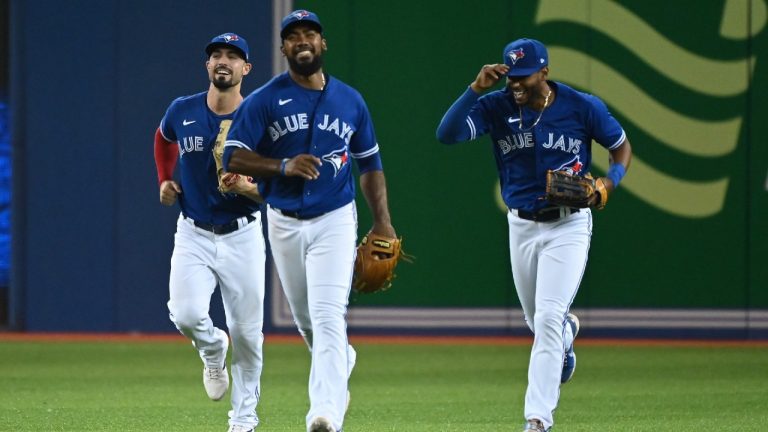 Toronto Blue Jays' Randal Grichuk, left, Teoscar Hernandez and Josh Palacios, right, celebrate their team's victory over the Chicago White Sox following an American League baseball game in Toronto on Wednesday, Aug. 25, 2021 (Jon Blacker/CP).