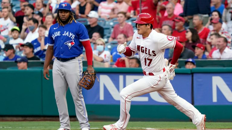 Los Angeles Angels' Shohei Ohtani, right, rounds first base past Toronto Blue Jays first baseman Vladimir Guerrero Jr. on a double during the first inning of a baseball game. (Marcio Jose Sanchez/AP) 
