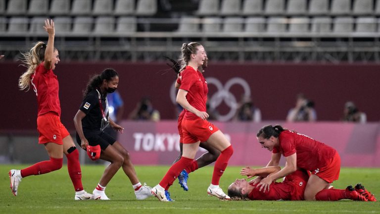 Canada's players celebrate after winning 1-0 to United States during a women's semifinal soccer match at the 2020 Summer Olympics. (Andre Penner/AP)