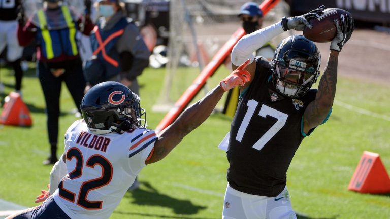 Jacksonville Jaguars wide receiver DJ Chark Jr. (17) catches a pass for a touchdown in front of Chicago Bears cornerback Kindle Vildor (22) during the first half of an NFL football game, Sunday, Dec. 27, 2020, in Jacksonville, Fla. (Phelan M. Ebenhack/AP)