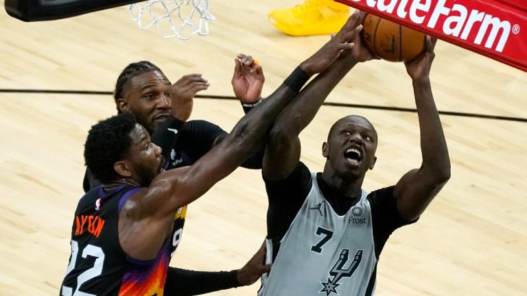 San Antonio Spurs center Gorgui Dieng (7) is fouled by Phoenix Suns center Deandre Ayton (22) during the first half of an NBA basketball game Saturday, April 17, 2021, in Phoenix. (Rick Scuteri/AP)