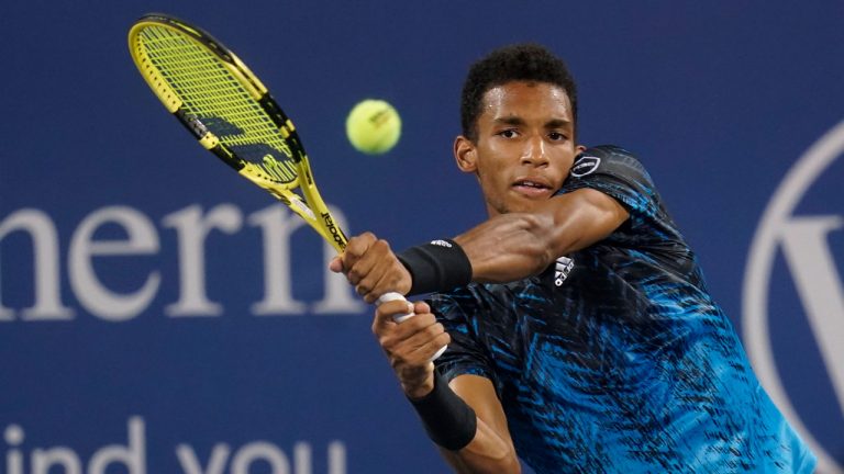 Felix Auger-Aliassime, of Canada, hits a return to Matteo Berrettini, of Italy, during the Western & Southern Open tennis tournament. (Darron Cummings/AP)