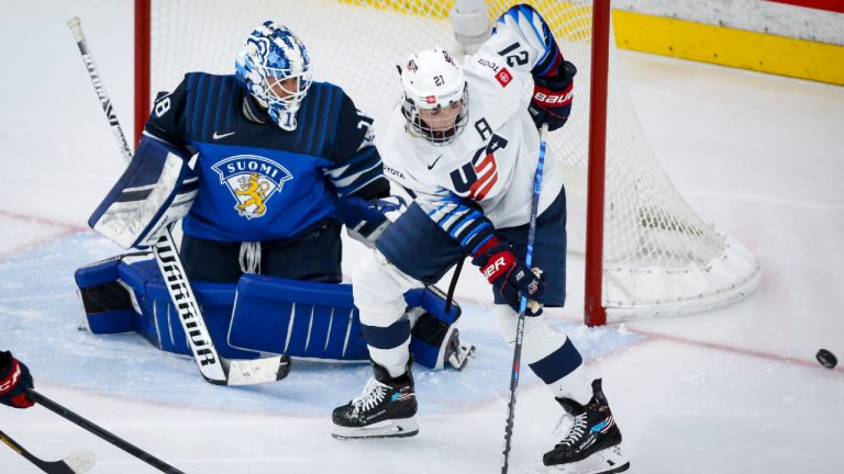 Hilary Knight, right, of the United States, tries for a lose puck as Finland's goalie Meeri Raisanen looks on during third period IIHF Women's World Championship hockey action in Calgary, Alta., Sunday, Aug. 22, 2021. (Jeff McIntosh/CP)