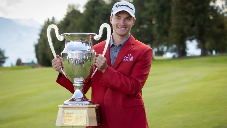 Rasmus Hojgaard of Denmark poses with the trophy after winning the European Masters Golf Tournament in Crans-Montana, Switzerland, Sunday, Aug. 29, 2021. Hojgaard fired a 7-under round of 63 with a flurry of birdies late in his round to win the European Masters on Sunday. He won by one stroke from Bernd Wiesberger who made double bogey at the 18th after hitting into green-side water. (Peter Klaunzer/Keystone via AP) 
