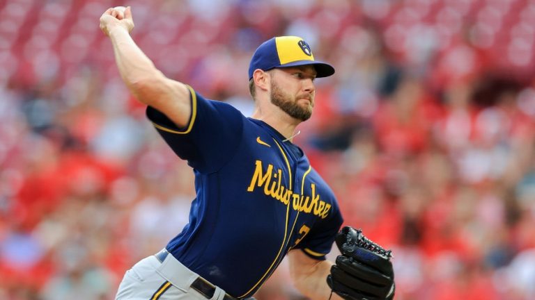 Milwaukee Brewers' Adrian Houser throws during the first inning of a baseball game against the Cincinnati Reds in Cincinnati, Friday, July 16, 2021. (Aaron Doster/AP) 