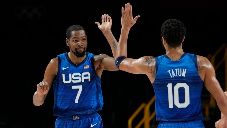 United States' Kevin Durant (7), left, and teammate Jayson Tatum (10) celebrate their win in the men's basketball quarterfinal game against Spain at the 2020 Summer Olympics. (Eric Gay/AP) 