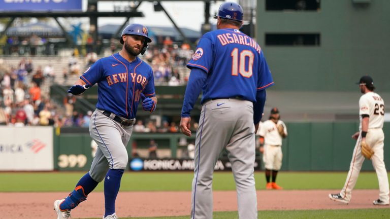 New York Mets' Kevin Pillar, left, is congratulated by third base coach Gary Disarcina (10) after hitting a three-run home run against the San Francisco Giants during the 12th inning of a baseball game. (Jeff Chiu/AP) 
