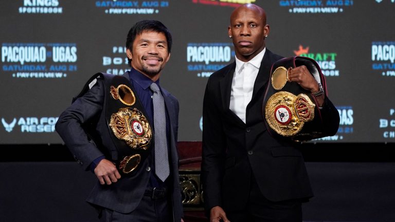Manny Pacquiao, left, of the Philippines, and Yordenis Ugas, of Cuba, pose for photographers during a news conference. (John Locher/AP) 