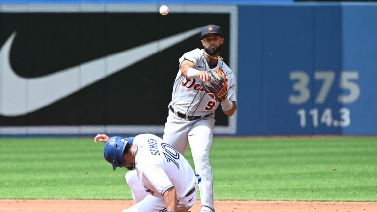 Detroit Tigers second baseman Willi Castro, right, throws to first base to complete a double play putting out Toronto Blue Jays' Vladimir Guerrero Jr. after forcing out Marcus Semien (10) at second base the third inning of an American League baseball game in Toronto on Sunday, Aug. 22, 2021. (Jon Blacker/CP)