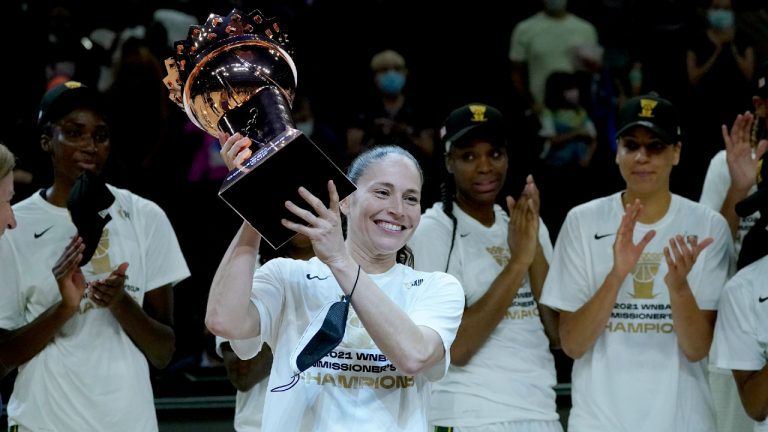 Seattle Storm guard Sue Bird holds the champions trophy after the Commissioner's Cup WNBA basketball game against the Connecticut Sun, Thursday, Aug. 12, 2021, in Phoenix. (Matt York/AP)