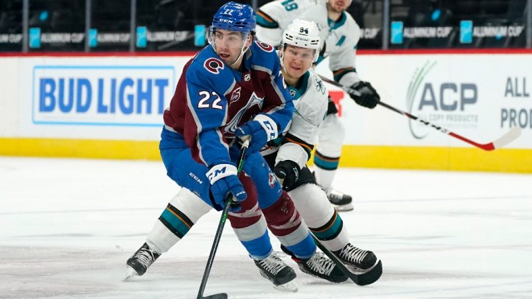Colorado Avalanche defenseman Conor Timmins, front, looks to pass the puck as San Jose Sharks left wing Alexander Barabanov defends in the first period of an NHL hockey game Saturday, May 1, 2021, in Denver. (David Zalubowski/AP)