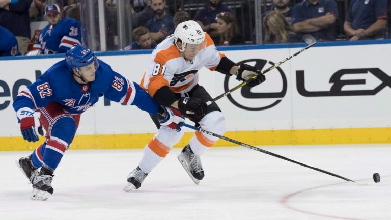 New York Rangers defenseman Joey Keane (82) and Philadelphia Flyers left wing Carsen Twarynski (81) battle for the puck during the first period of a preseason NHL hockey game, Wednesday, Sept. 19, 2018, at Madison Square Garden in New York. (Mary Altaffer/AP)