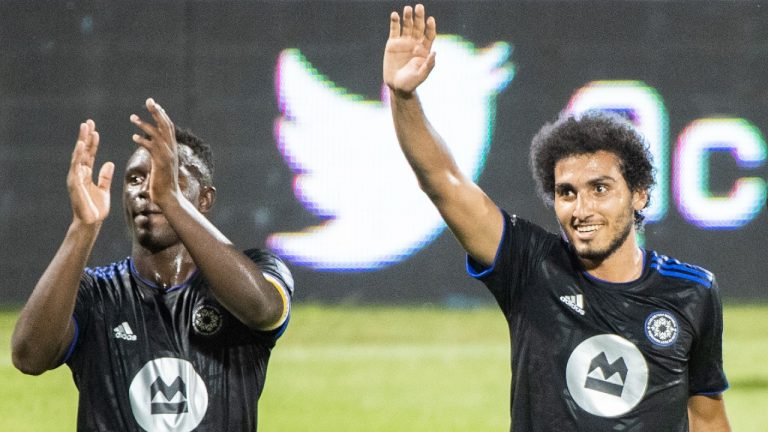 CF Montreal's Ahmed Hamdi, right, and teammate Victor Wanyama (2) salute the crowd after defeating FC Cincinnati in an MLS soccer game in Montreal, Saturday, July 17, 2021. (Graham Hughes/CP)