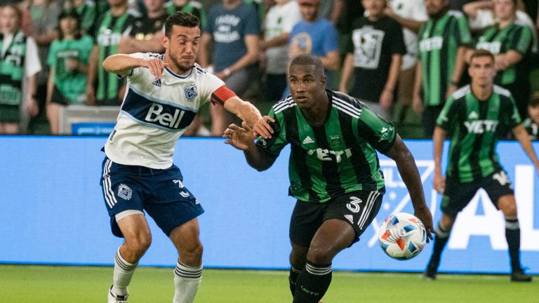 Austin FC defender Jhohan Romana (3) and Vancouver Whitecaps midfielder Russell Teibert vie for the ball during the first half of an MLS soccer match. (Michael Thomas/AP) 