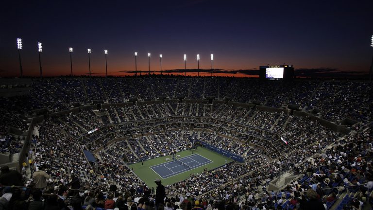 The sun sets over the skyline of New York and Arthur Ashe Stadium during the opening night of the U.S. Open tennis tournament in New York. (Amy Sancetta/AP, File)
