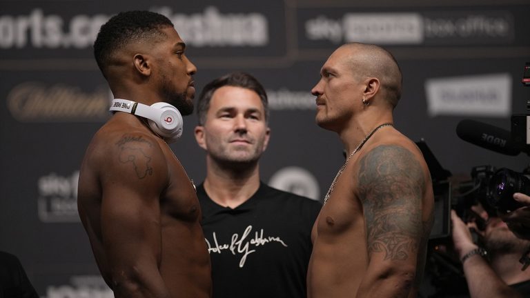 Britain's Anthony Joshua, left and Oleksandr Usyk of the Ukraine pose for the media during the weigh-in for their upcoming boxing match at the O2 Arena in London, Friday, Sept. 24, 2021. (Mat Dunham/AP)