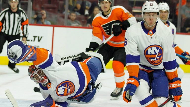 New York Islanders goalie Jeremey Smith, left, dives to stop a shot on goal while Bode Wilde, right, adds to the effort during the second period of an NHL preseason hockey game against the Philadelphia Flyers, Monday, Sept, 17, 2018, in Philadelphia (Tom Mihalek/AP).